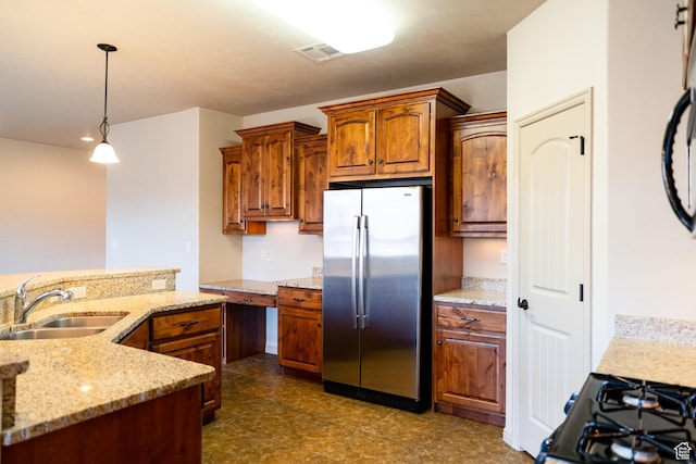 2710 W 410 N, Hurricane, UT 84737 - kitchen with freestanding refrigerator, a sink, decorative light fixtures, brown cabinets, and light stone counters