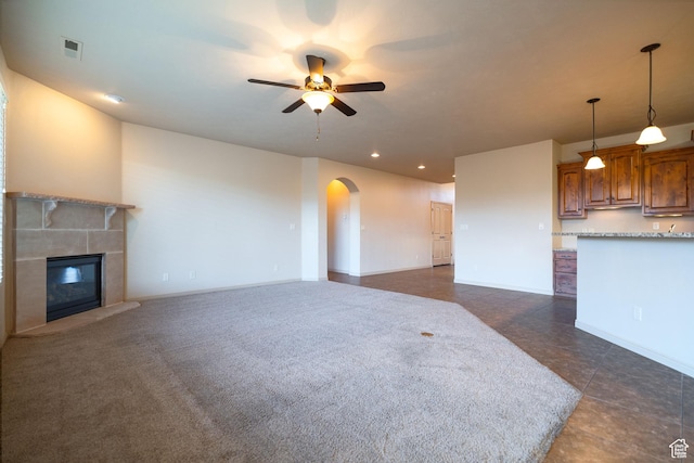 2710 W 410 N, Hurricane, UT 84737 - unfurnished living room featuring a ceiling fan, arched walkways, a fireplace, baseboards, and recessed lighting