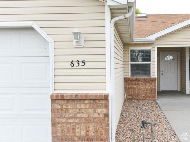 635 E Hunter Way N, Grantsville, UT 84029 - entrance to property with an attached garage and brick siding