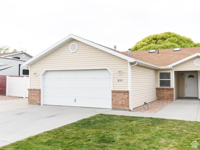 635 E Hunter Way N, Grantsville, UT 84029 - ranch-style home with brick siding, driveway, and an attached garage
