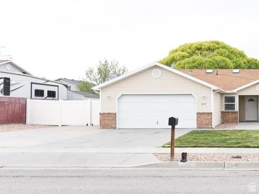 635 E Hunter Way N, Grantsville, UT 84029 - view of front of home featuring brick siding, driveway, and an attached garage