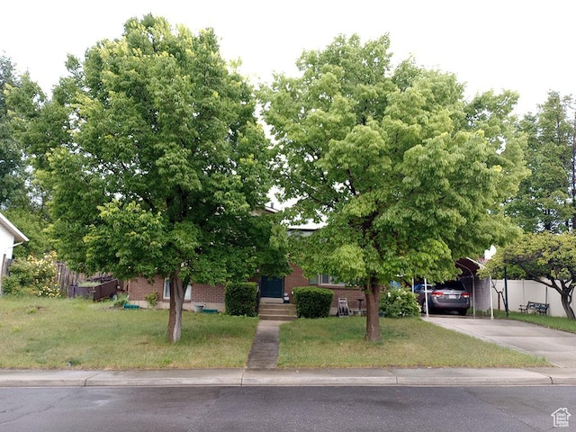 56 N 970 W, Orem, UT 84057 - obstructed view of property with a carport, brick siding, and driveway