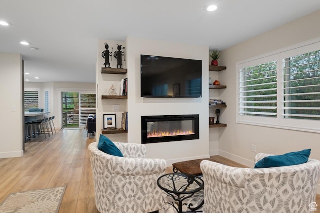 1288 E Foxcrest Ct, Park City, UT 84098 - living area featuring a glass covered fireplace, light wood-type flooring, baseboards, and recessed lighting
