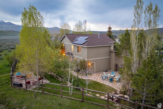 1288 E Foxcrest Ct, Park City, UT 84098 - back of property with a patio area, roof mounted solar panels, a mountain view, and roof with shingles