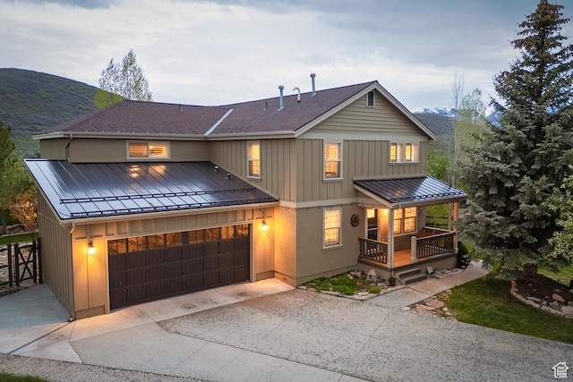 1288 E Foxcrest Ct, Park City, UT 84098 - view of front of house featuring a standing seam roof, metal roof, a porch, concrete driveway, and a garage