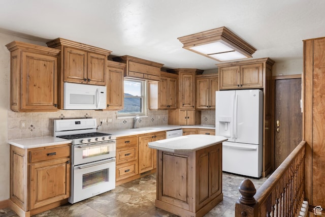 5685 N State Road 32, Peoa, UT 84061 - kitchen with white appliances, a sink, backsplash, light countertops, and a center island