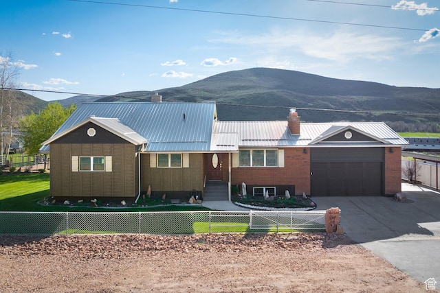 5685 N State Road 32, Peoa, UT 84061 - ranch-style house featuring a mountain view, a fenced front yard, a garage, and driveway