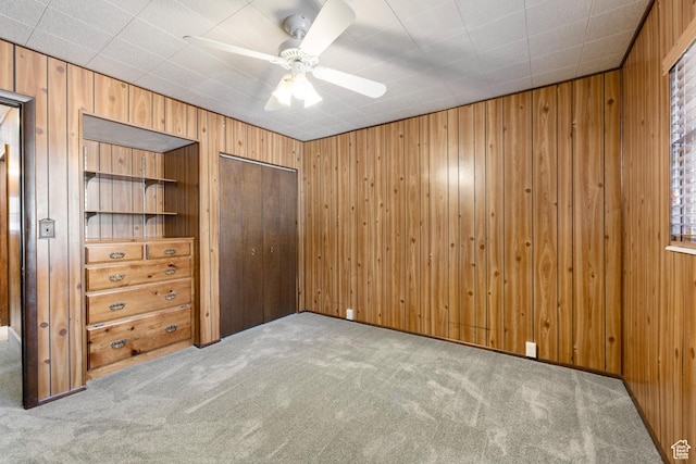 5685 N State Road 32, Peoa, UT 84061 - unfurnished bedroom featuring carpet flooring, wood walls, a closet, and ceiling fan