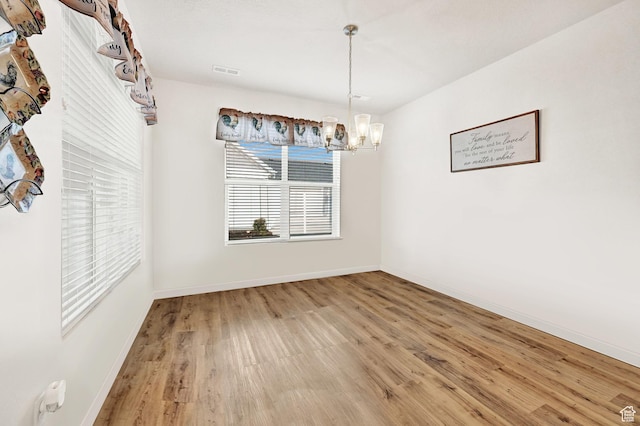 114 N 3830 W, West Point, UT 84015 - unfurnished dining area with wood finished floors, a chandelier, and baseboards