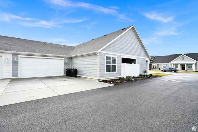114 N 3830 W, West Point, UT 84015 - view of property exterior featuring driveway, an attached garage, cooling unit, and roof with shingles
