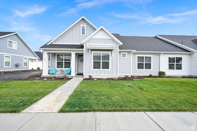114 N 3830 W, West Point, UT 84015 - view of front of home with covered porch, board and batten siding, a front yard, and a shingled roof