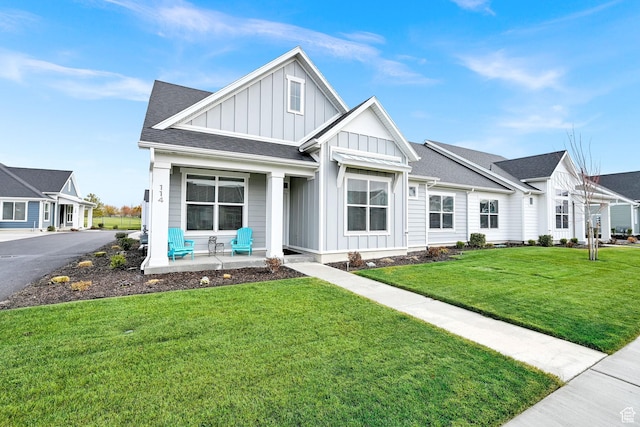 114 N 3830 W, West Point, UT 84015 - view of front of home with board and batten siding, a porch, a front lawn, and roof with shingles