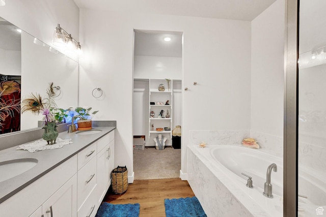 114 N 3830 W, West Point, UT 84015 - full bathroom with a spacious closet, wood finished floors, double vanity, and a garden tub
