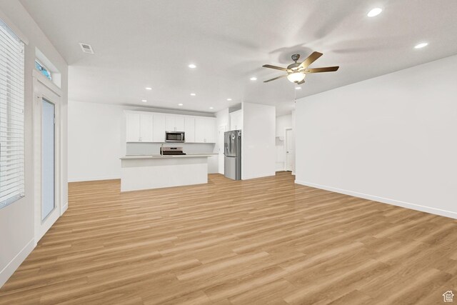 114 N 3830 W, West Point, UT 84015 - unfurnished living room featuring light wood finished floors, a ceiling fan, and recessed lighting