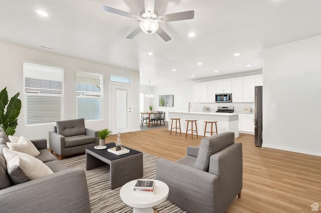 114 N 3830 W, West Point, UT 84015 - living area with light wood-style floors, a ceiling fan, and recessed lighting