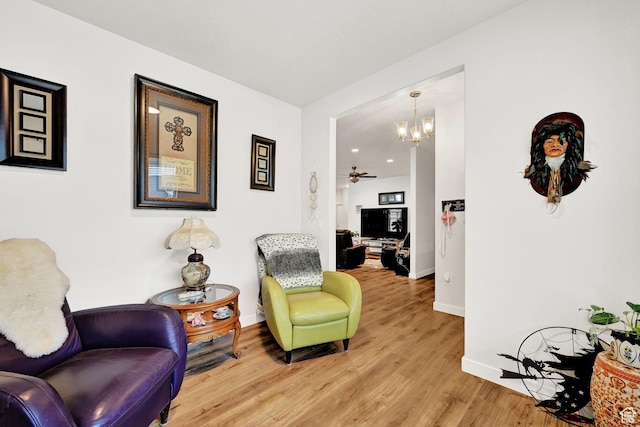 114 N 3830 W, West Point, UT 84015 - living area featuring baseboards, a chandelier, light wood finished floors, and a ceiling fan