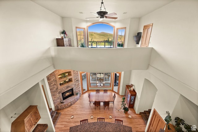 9266 Par Ct, Park City, UT 84098 - living area with ceiling fan, a brick fireplace, wood finished floors, and a chandelier