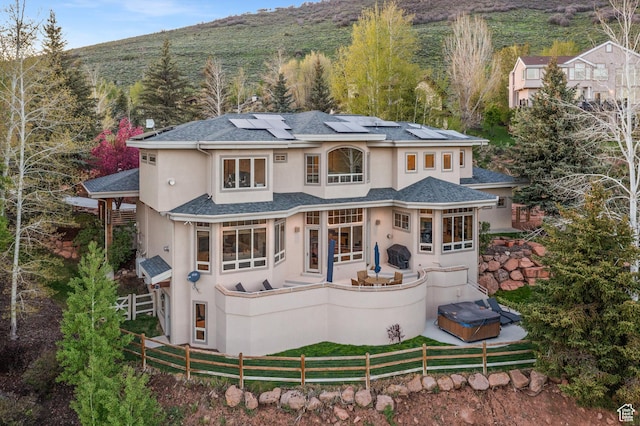 9266 Par Ct, Park City, UT 84098 - back of house with stucco siding, roof mounted solar panels, and roof with shingles