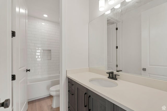 669 Juniper Hill Dr, St George, UT 84790 - bathroom with toilet, vanity, wood finished floors, and  shower combination