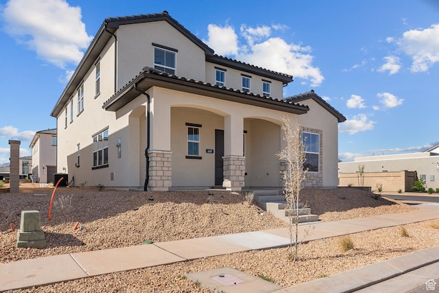 669 Juniper Hill Dr, St George, UT 84790 - mediterranean / spanish house with a porch, stucco siding, stone siding, and a tile roof