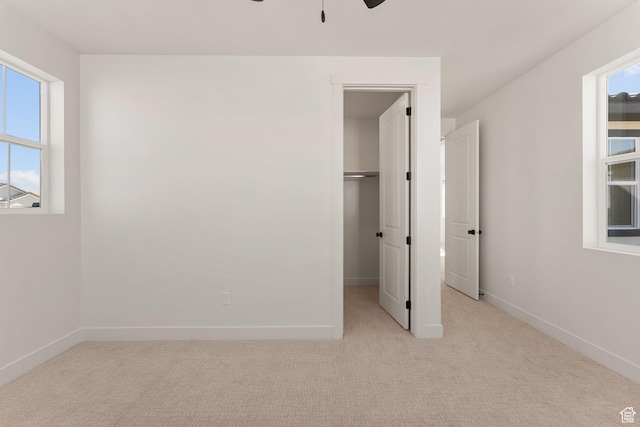 669 Juniper Hill Dr, St George, UT 84790 - unfurnished bedroom featuring light colored carpet, a spacious closet, baseboards, and a ceiling fan