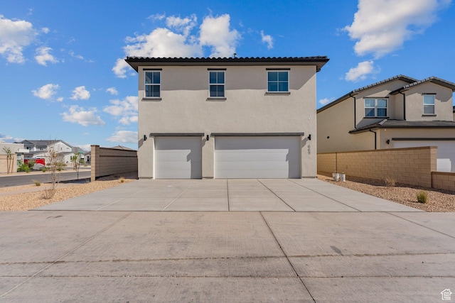 669 Juniper Hill Dr, St George, UT 84790 - view of front of home featuring an attached garage, stucco siding, concrete driveway, and a tile roof