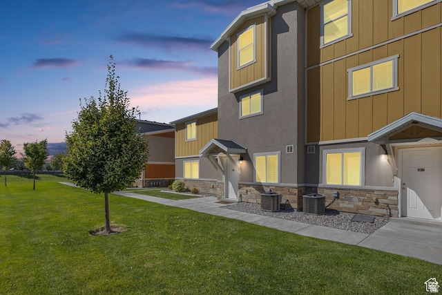 236 E 630 N, Vineyard, UT 84059 - view of front of property featuring stone siding, central AC, a front yard, and board and batten siding