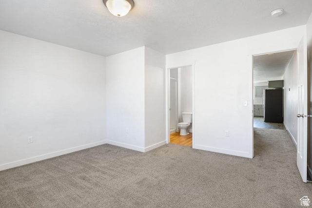 236 E 630 N, Vineyard, UT 84059 - unfurnished bedroom featuring carpet, baseboards, freestanding refrigerator, and ensuite bathroom