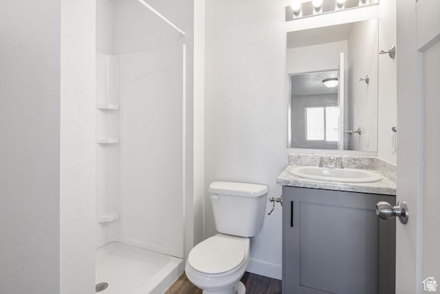 236 E 630 N, Vineyard, UT 84059 - bathroom featuring a stall shower, vanity, toilet, baseboards, and wood finished floors