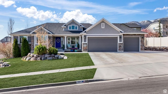 391 W Birch Dr, Saratoga Springs, UT 84045 - craftsman-style house with a garage, driveway, stone siding, and a front lawn
