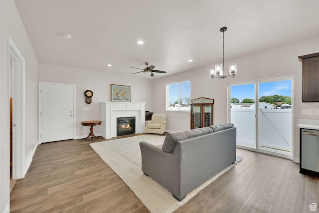 250 W 1200 S Unit 127, Tremonton, UT 84337 - living room featuring a glass covered fireplace, ceiling fan, light wood-style floors, recessed lighting, and a chandelier