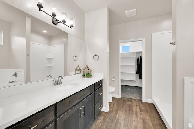250 W 1200 S Unit 127, Tremonton, UT 84337 - full bathroom featuring vanity, wood finished floors, a spacious closet, and a shower