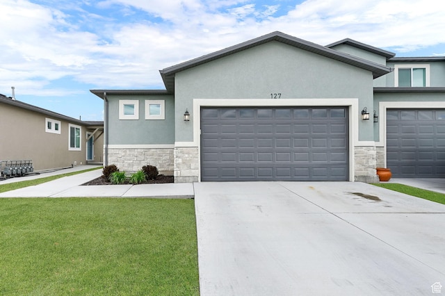 250 W 1200 S Unit 127, Tremonton, UT 84337 - view of front of house with stone siding, stucco siding, an attached garage, and driveway