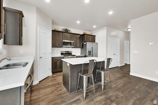 250 W 1200 S Unit 127, Tremonton, UT 84337 - kitchen featuring appliances with stainless steel finishes, a kitchen bar, dark wood-style floors, dark brown cabinetry, and recessed lighting