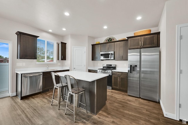 250 W 1200 S Unit 127, Tremonton, UT 84337 - kitchen featuring stainless steel appliances, dark brown cabinetry, a kitchen island, dark wood finished floors, and light countertops