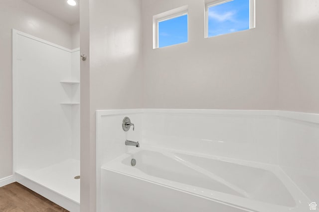 250 W 1200 S Unit 127, Tremonton, UT 84337 - full bathroom featuring a garden tub, wood finished floors, and a stall shower