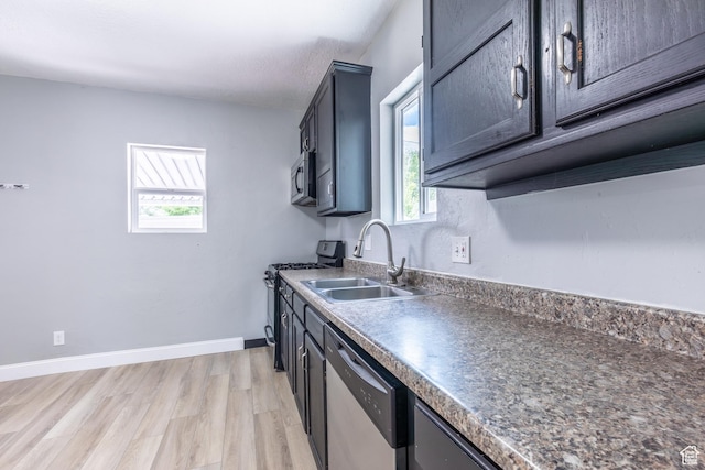 2665 S 8900 W, Magna, UT 84044 - kitchen featuring appliances with stainless steel finishes, a sink, healthy amount of natural light, and light wood finished floors