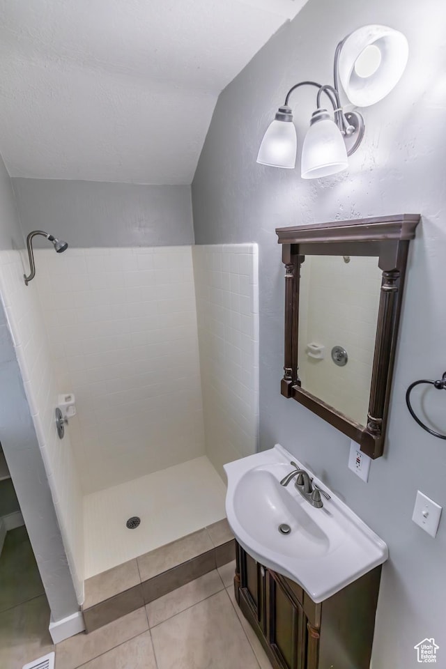 2665 S 8900 W, Magna, UT 84044 - full bath with vaulted ceiling, a tile shower, tile patterned flooring, and vanity
