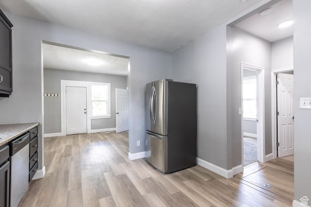 2665 S 8900 W, Magna, UT 84044 - kitchen with stainless steel appliances, light wood-style flooring, light countertops, and baseboards