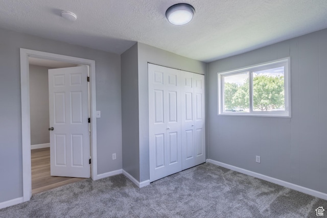 2665 S 8900 W, Magna, UT 84044 - unfurnished bedroom featuring carpet flooring, a closet, a textured ceiling, and baseboards