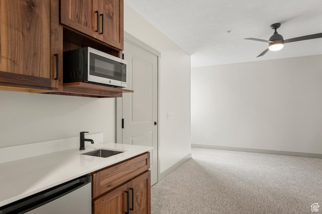 35 E 150 S Unit 202C, Garden City, UT 84028 - kitchen with appliances with stainless steel finishes, light carpet, a sink, light countertops, and ceiling fan