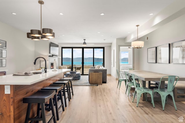 35 E 150 S Unit 202C, Garden City, UT 84028 - dining space featuring light wood-style flooring, a chandelier, recessed lighting, and baseboards