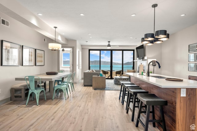 35 E 150 S Unit 202C, Garden City, UT 84028 - dining room featuring a chandelier, light wood-style floors, baseboards, recessed lighting, and a ceiling fan