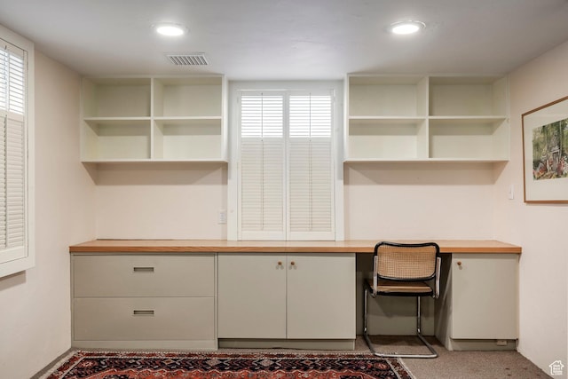 unfurnished office with built in desk and recessed lighting