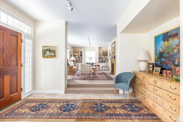 entrance foyer featuring light tile patterned floors and baseboards
