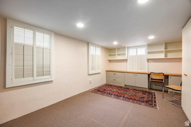 office with built in study area, carpet floors, and recessed lighting
