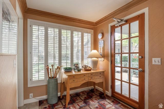 entryway featuring baseboards, ornamental molding, and healthy amount of natural light
