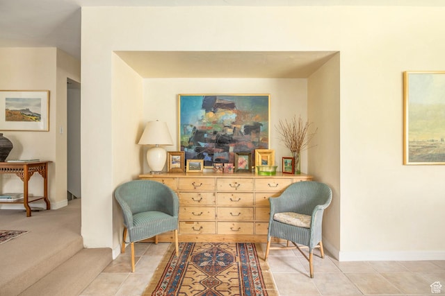 living area with baseboards and light tile patterned flooring
