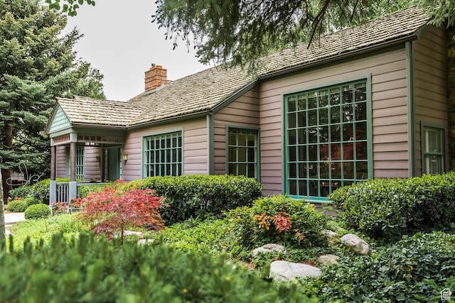 back of property with a chimney