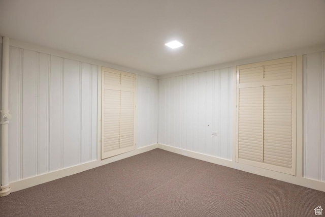 unfurnished bedroom featuring dark colored carpet